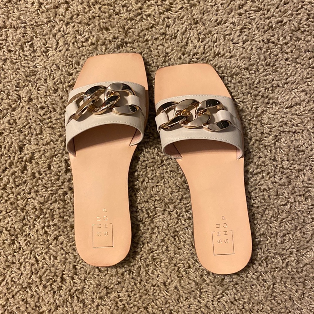 White sandals with gold buckle